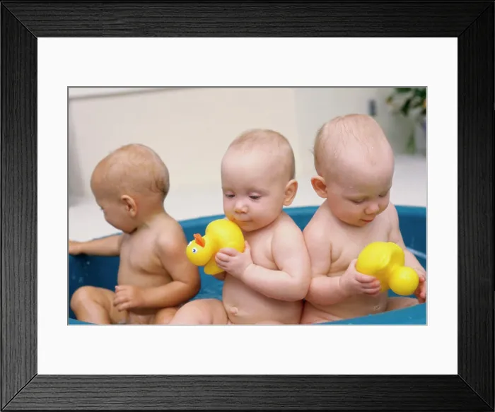 Framed Print : Three baby boys playing with rubber ducks