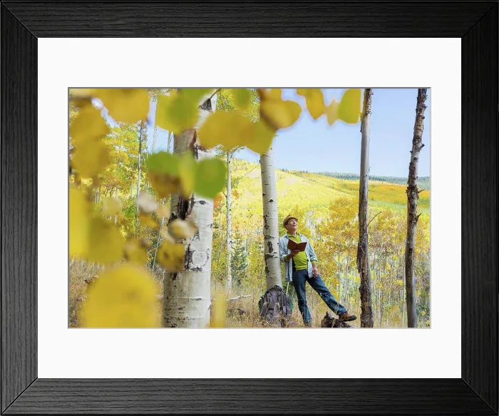 Framed Print : Man reading book in autumn forest Framed Print : Man reading book in autumn forest