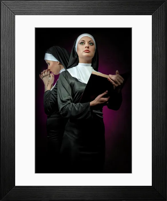Framed Print : Two attractive young nuns with rosary and bible praying Two attractive young nuns with rosary and bible praying
