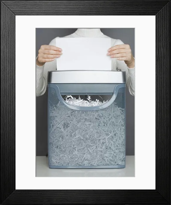 Framed Print : Woman using a paper shredder