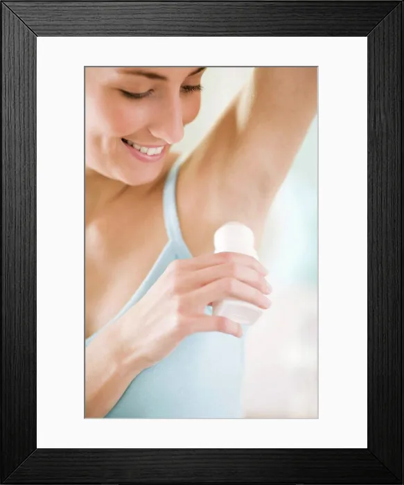 Framed Print : Woman applying deodorant Framed Print : Woman applying deodorant