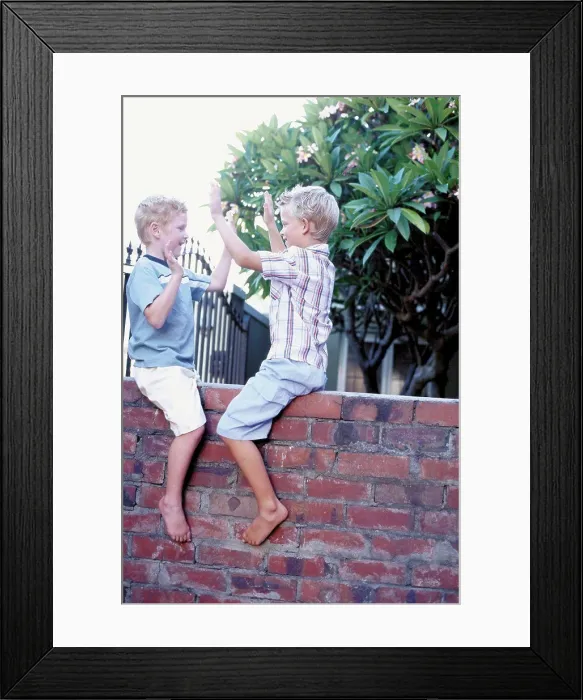 Framed Print : Boys playing on wall Framed Print : Boys playing on wall