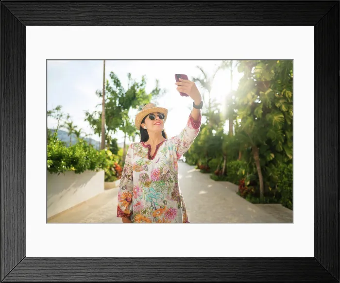 Framed Print : Smiling woman takes a selfie in the backyard of her house Framed Print : Smiling woman takes a selfie in the backyard of her house