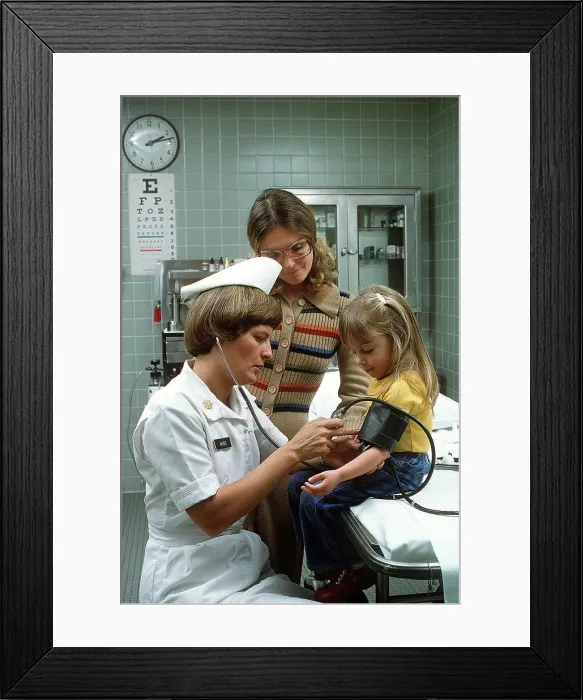 Framed Print : 1977 - A nurse takes a child's blood pressure Framed Print : 1977 - A nurse takes a child's blood pressure