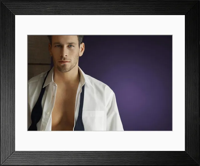 Framed Print : Portrait of a smart man wearing unbuttoned shirt over purple background Framed Print : Portrait of a smart man wearing unbuttoned shirt over purple background