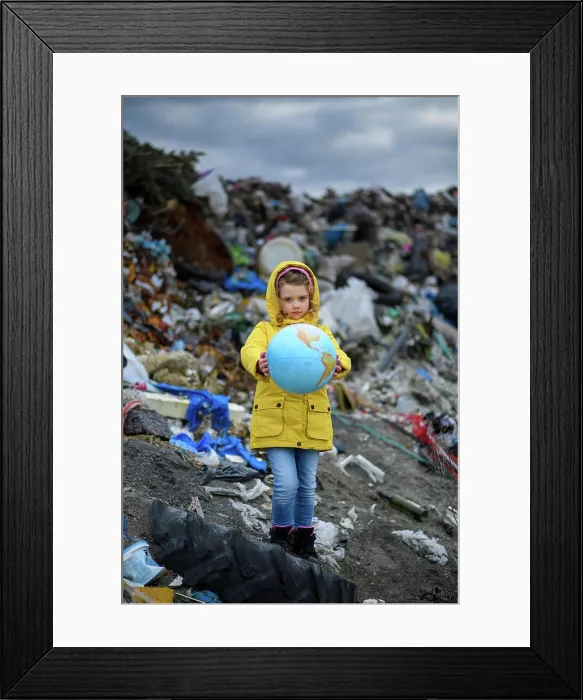 Framed Print : Young girl holding planet Earth model Framed Print : Young girl holding planet Earth model