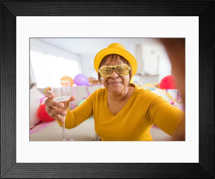 Framed Print : Senior woman in shutter glasses making video call while enjoying champagne during party at home