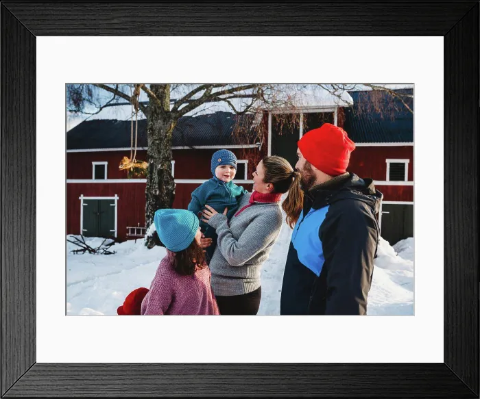 Framed Print : Happy family gathered by red Scandinavian bar in cold winter with snow