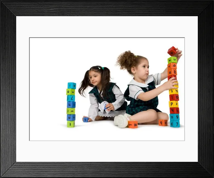 Framed Print : Girls playing with plastic blocks