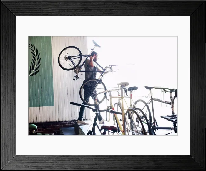 Framed Print : A man working in a bicycle repair shop Framed Print : A man working in a bicycle repair shop