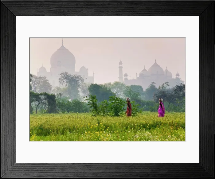 Framed Print : Exterior view of the Taj Mahal in Agra, India. Two woman in the foreground carrying loads on their heads