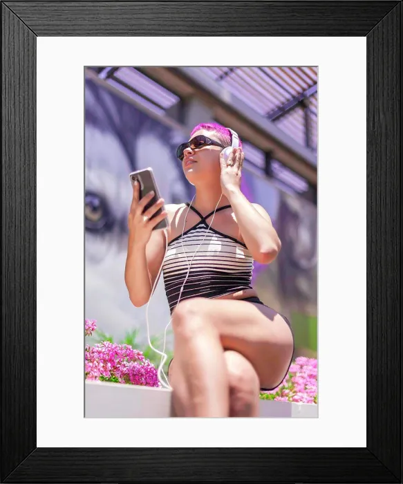 Framed Print : Woman with purple hair and headpones is listening music in her mobile Framed Print : Woman with purple hair and headpones is listening music in her mobile