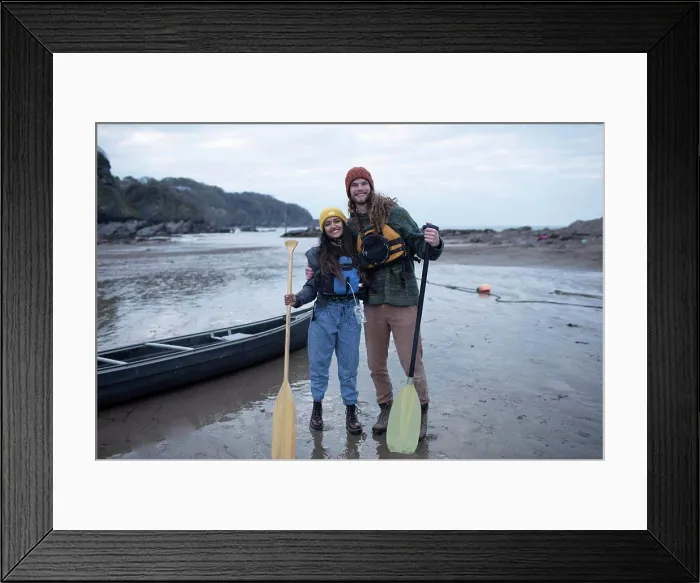 Framed Print : Portrait happy couple with canoe and oars on beach