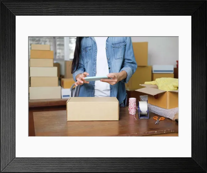 Framed Print : Online business owner preparing product to customer