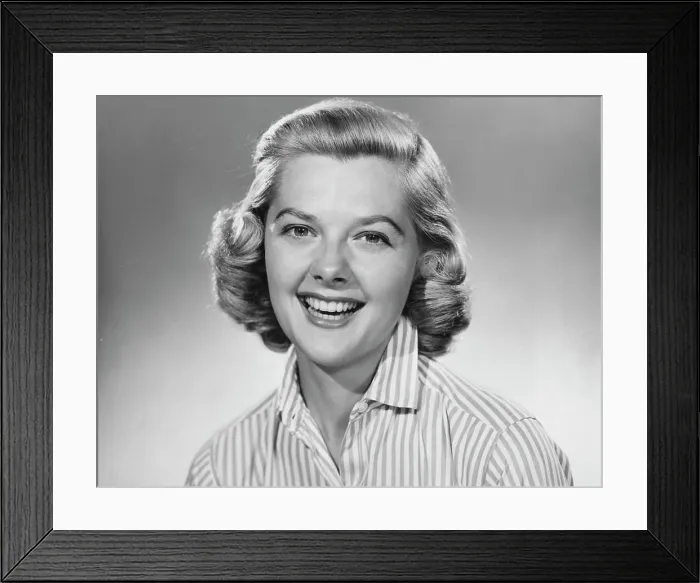 Framed Print : Studio portrait of young woman smiling Framed Print : Studio portrait of young woman smiling