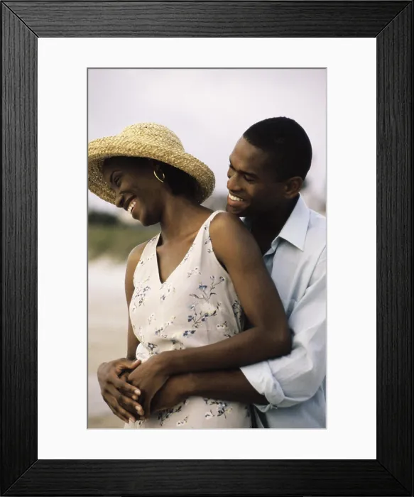 Framed Print : Young couple holding each other on the beach Framed Print : Young couple holding each other on the beach