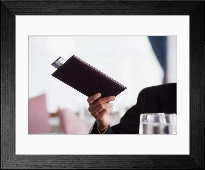 Framed Print : Businessman paying the check at restaurant