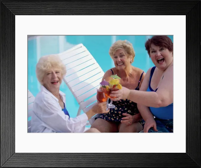Framed Print : Portrait of three senior women toasting glasses of red wine