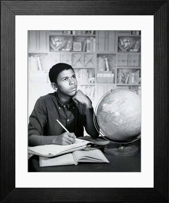 Framed Print : Close-up of a teenage boy sitting at the table and thinking Framed Print : Close-up of a teenage boy sitting at the table and thinking