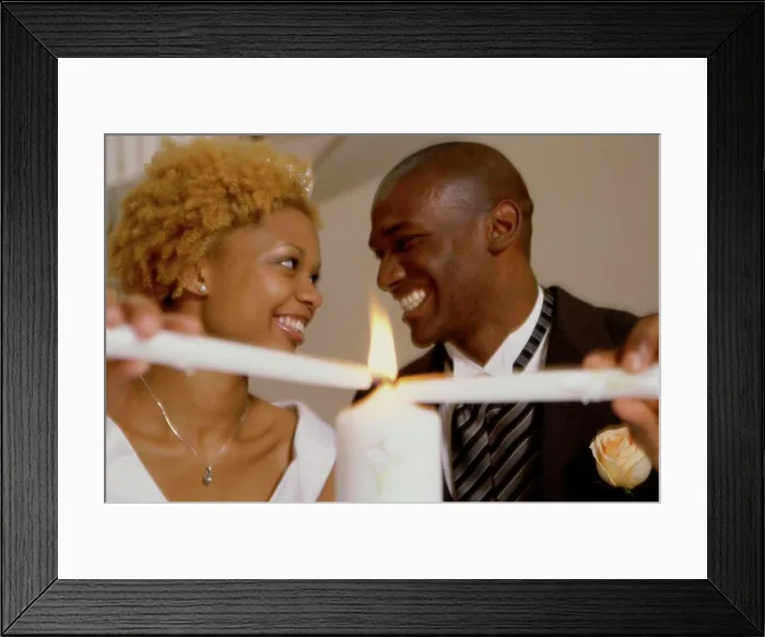 Framed Print : Newlywed couple lighting candles Framed Print : Newlywed couple lighting candles
