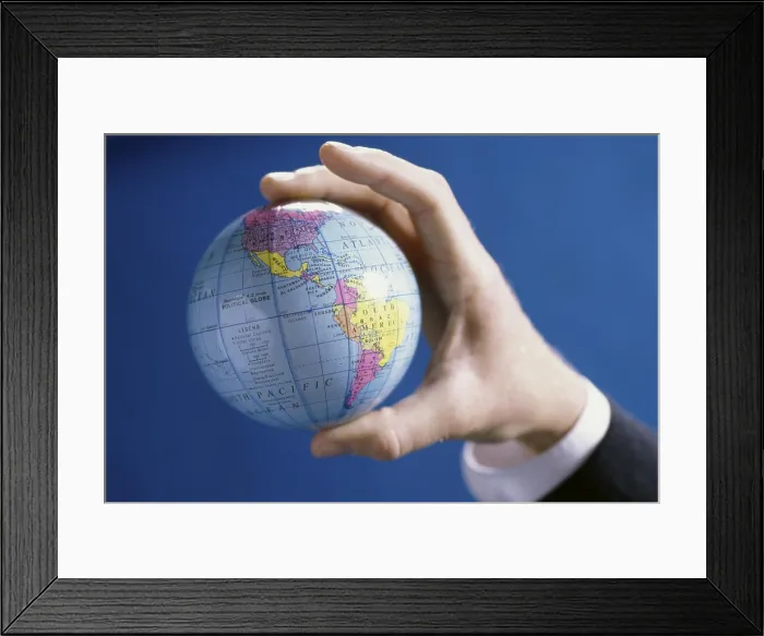 Framed Print : Close-up of a person's hands holding a globe
