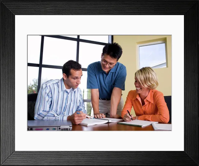 Framed Print : Two businessmen and a businesswoman reading documents Framed Print : Two businessmen and a businesswoman reading documents