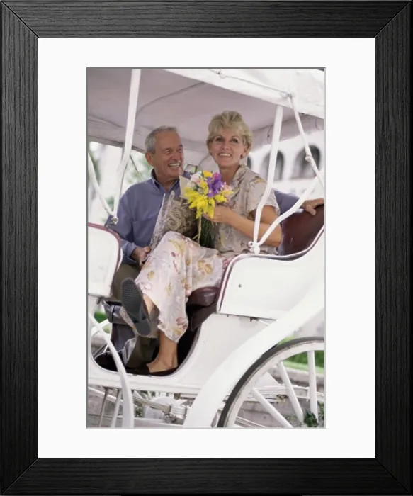 Framed Print : Low angle view of a senior couple in a carriage Framed Print : Low angle view of a senior couple in a carriage