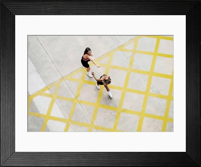 Framed Print : Multi-ethnic female friends boxing on yellow patterned footpath Framed Print : Multi-ethnic female friends boxing on yellow patterned footpath