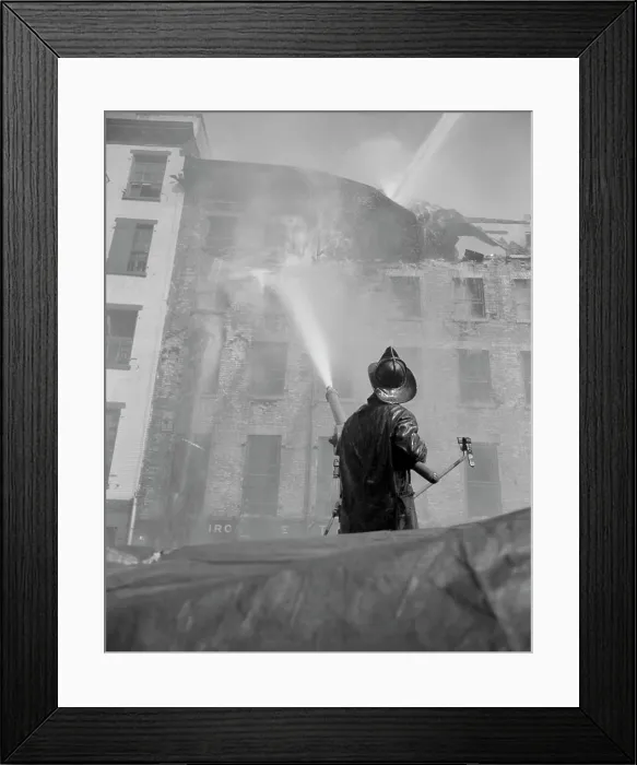 Framed Print : Firefighter pouring water on burning building, low angle view Framed Print : Firefighter pouring water on burning building, low angle view