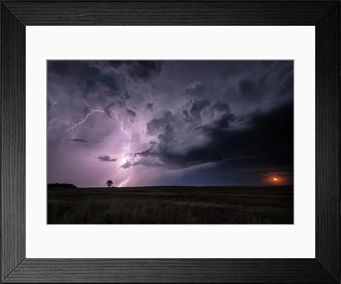 Framed Print : A rising moon and a storm with lightning striking over field in rural North Dakota United States Framed Print : A rising moon and a storm with lightning striking over field in rural North Dakota United States