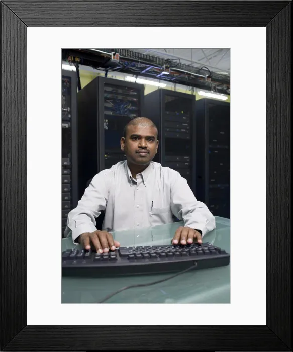 Framed Print : Portrait of a technician working on a network server Framed Print : Portrait of a technician working on a network server
