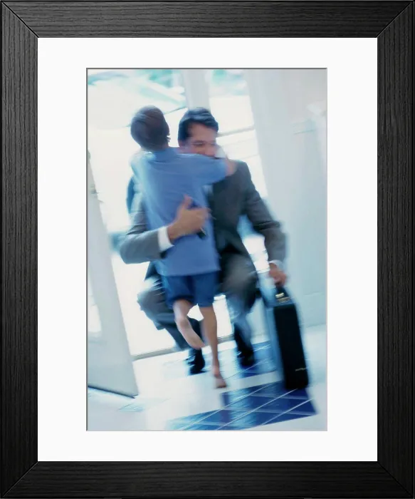 Framed Print : Businessman hugging his son at the door Framed Print : Businessman hugging his son at the door