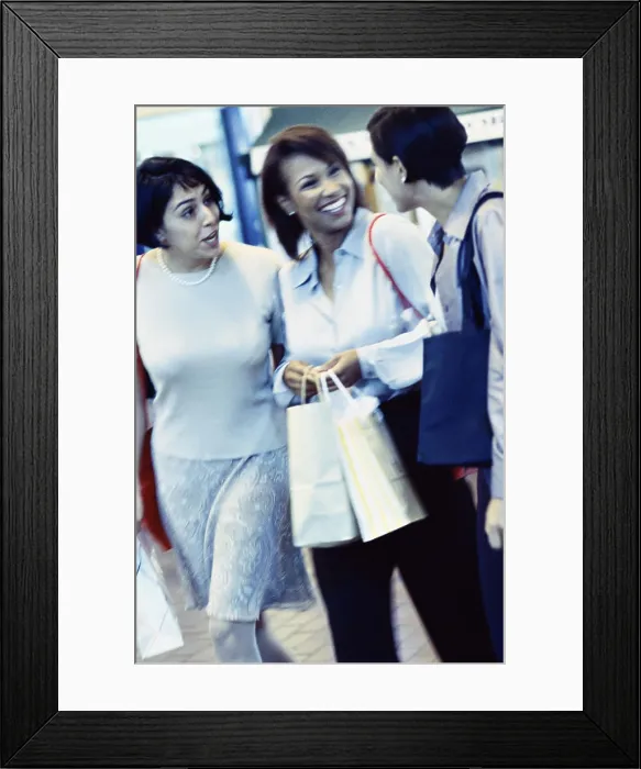 Framed Print : Side profile of three young women carrying shopping bags Framed Print : Side profile of three young women carrying shopping bags