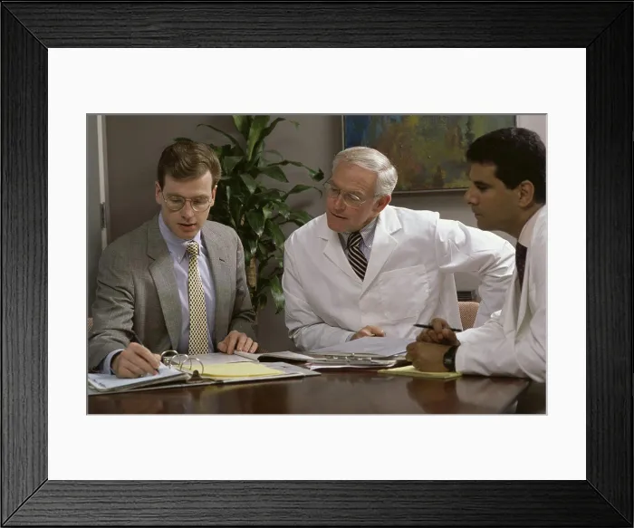 Framed Print : Three male doctors talking in a conference room Framed Print : Three male doctors talking in a conference room
