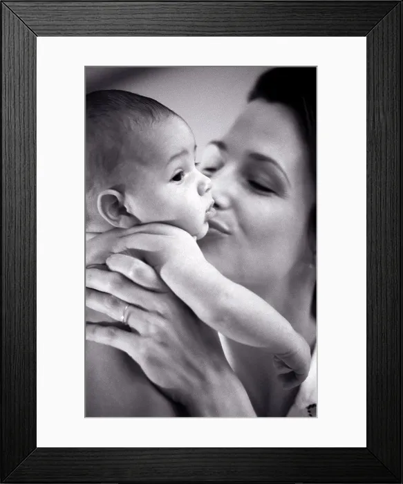 Framed Print : Close-up of a mother kissing her baby boy Framed Print : Close-up of a mother kissing her baby boy