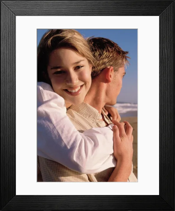 Framed Print : Portrait of a teenage girl hugging a young man Framed Print : Portrait of a teenage girl hugging a young man