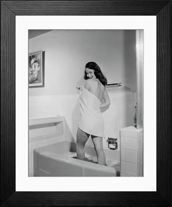 Framed Print : Woman wrapped in towel standing in bath tub Framed Print : Woman wrapped in towel standing in bath tub