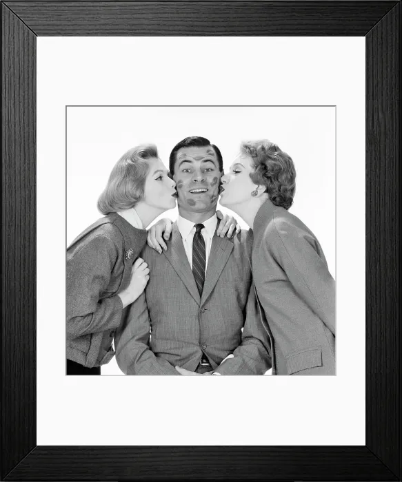 Framed Print : 1950s 1960s SMILING SINGLE MAN LOOKING AT CAMERA BEING KISSED BY TWO WOMEN