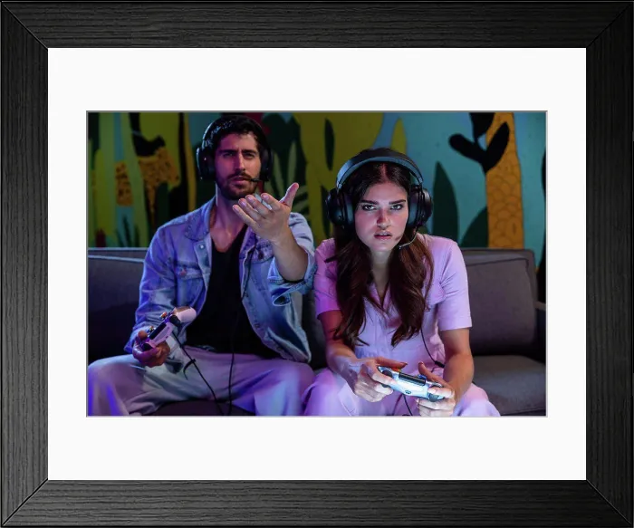 Framed Print : Man and woman playing video games at home wearing headsets Framed Print : Man and woman playing video games at home wearing headsets