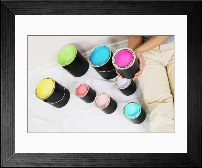 Framed Print : High angle view of a woman sitting with paint cans beside her Framed Print : High angle view of a woman sitting with paint cans beside her