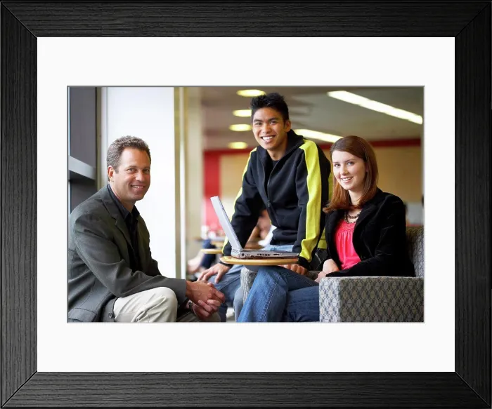 Framed Print : Male professor sitting with his students and smiling Framed Print : Male professor sitting with his students and smiling