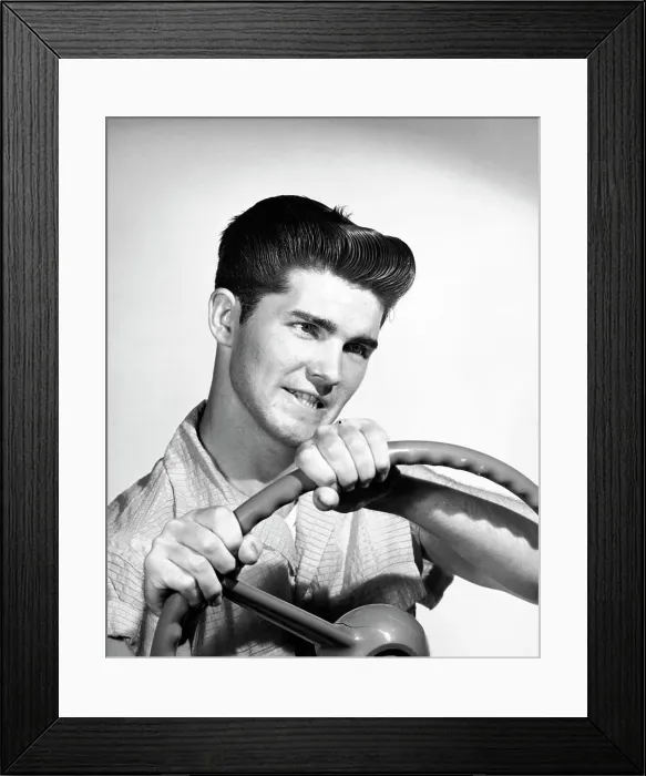Framed Print : Close-up of a young man holding a steering wheel Framed Print : Close-up of a young man holding a steering wheel