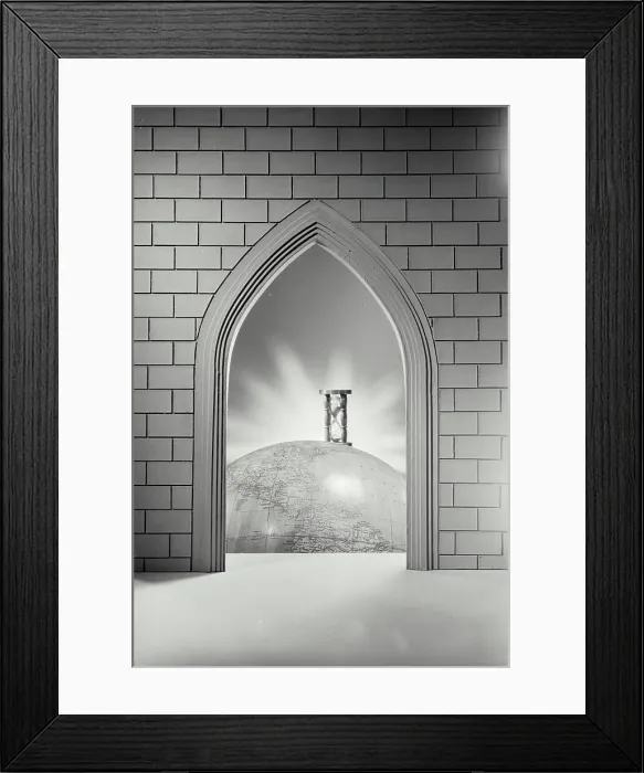 Framed Print : Vintage photograph. Photo illustration of pointed brick arch looking through to sand timer sitting on globe of the world