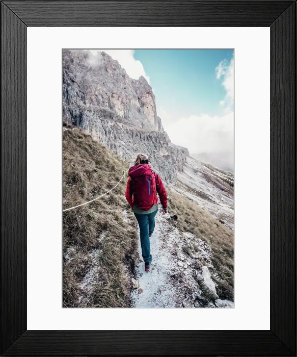 Framed Print : Young female mountaineer hikes towards rock face in Italian Dolomites Framed Print : Young female mountaineer hikes towards rock face in Italian Dolomites
