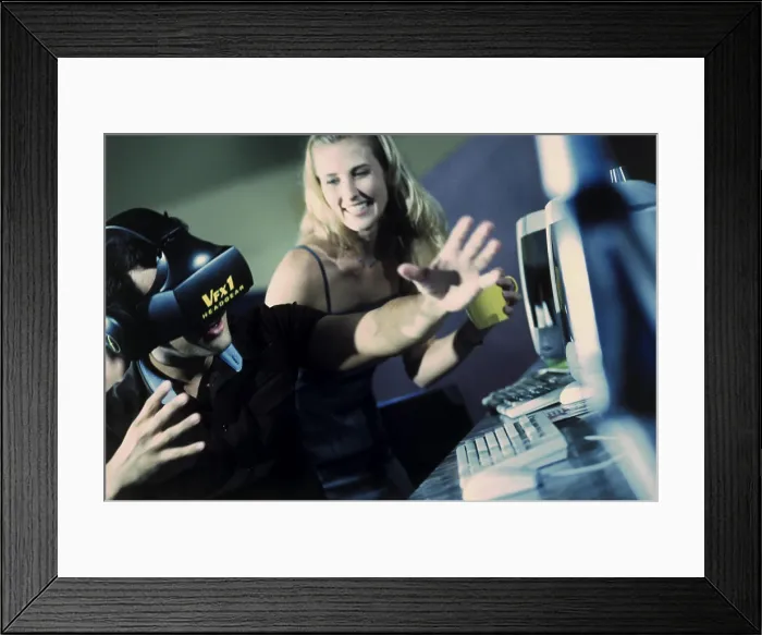 Framed Print : Side profile of a young man wearing a virtual reality simulator with a young woman sitting beside him in front of Framed Print : Side profile of a young man wearing a virtual reality simulator with a young woman sitting beside him in front of