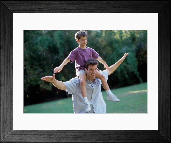 Framed Print : Father carrying his son on his shoulders Framed Print : Father carrying his son on his shoulders
