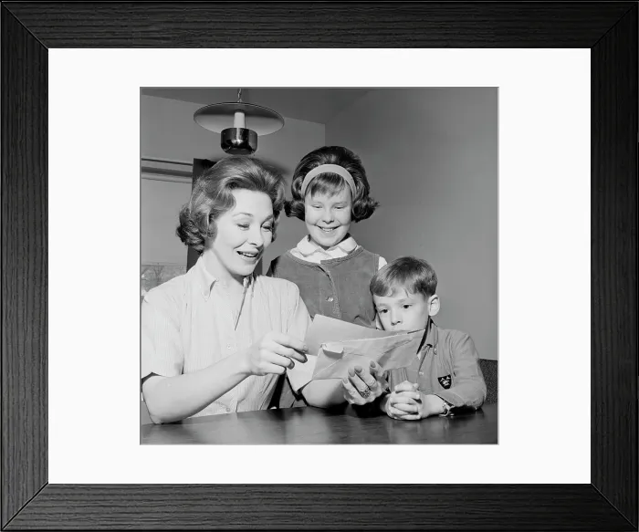 Framed Print : Girl and boy are watching as cheerful mother is reading letter