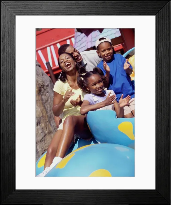 Framed Print : Portrait of parents and their two children in an amusement park Framed Print : Portrait of parents and their two children in an amusement park