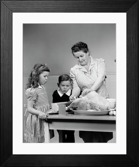 Framed Print : 1940S Mother Son Daughter In Kitchen Stuffing Turkey For Thanksgiving Dinner Framed Print : 1940S Mother Son Daughter In Kitchen Stuffing Turkey For Thanksgiving Dinner