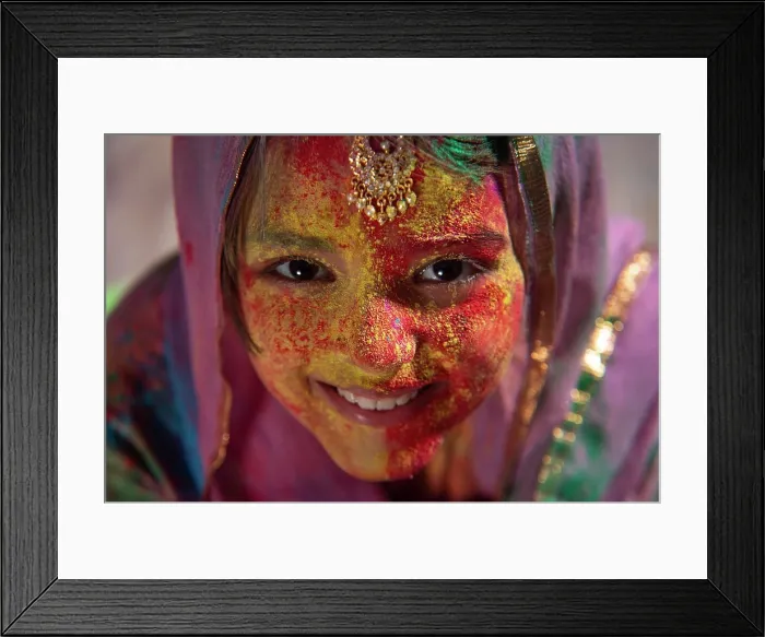Framed Print : Portrait of a young girl with duapatta and mangtika on her head smiling on Holi Framed Print : Portrait of a young girl with duapatta and mangtika on her head smiling on Holi